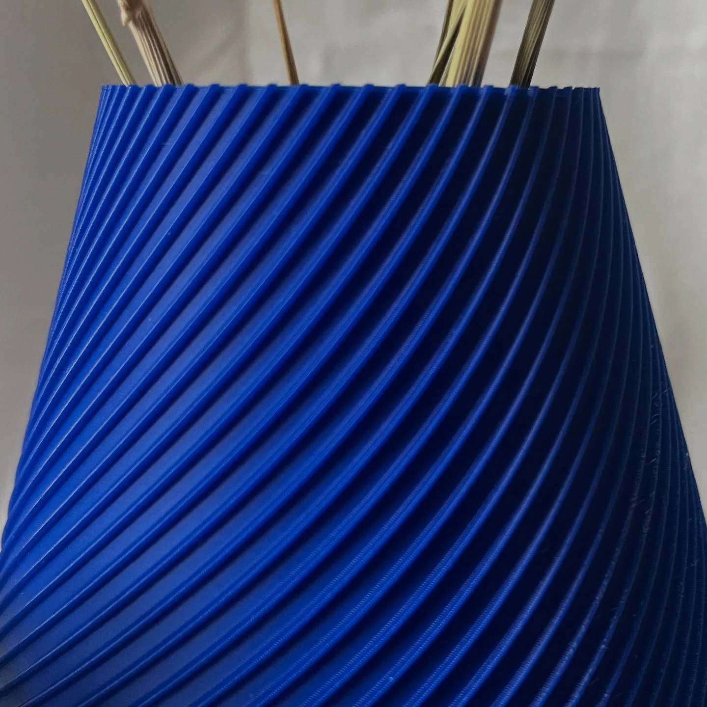 Close-up of the printed layers and spiral ribs of a cobalt Vertigo vase